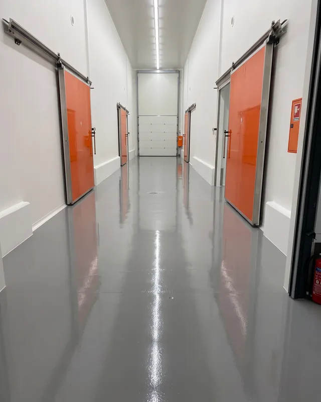 Corridor with the orange doors of the cold rooms at the Mintzilis packing house